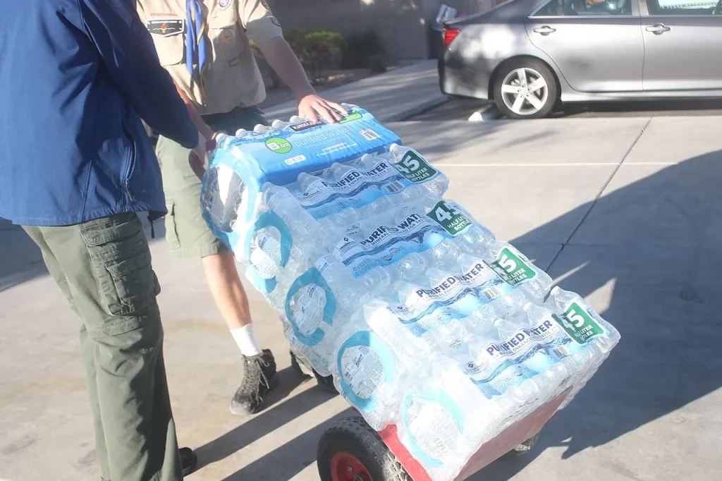 Volunteers moving donated cases of bottled water