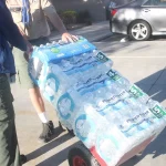 Volunteers moving donated cases of bottled water