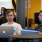 programmer reviewing code on a monitor