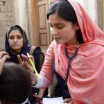 Doctor examining a woman patient