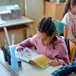 Students in a classroom studying without smartphones on their desks