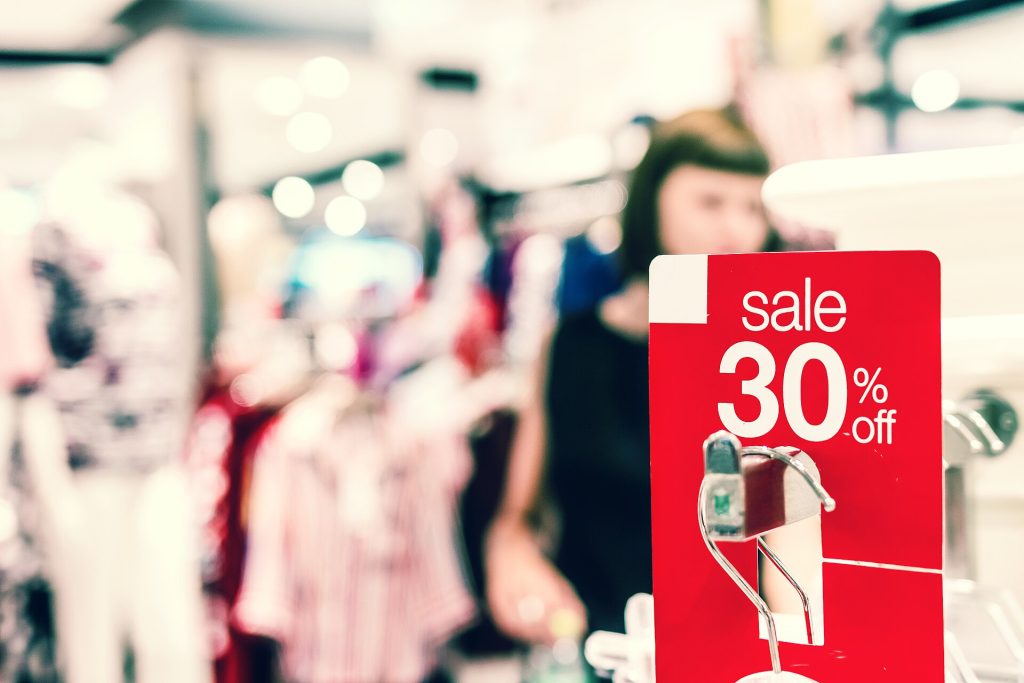 Red sale sign showing a 30 percent discount in a shopping mall