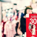 Red sale sign showing a 30 percent discount in a shopping mall